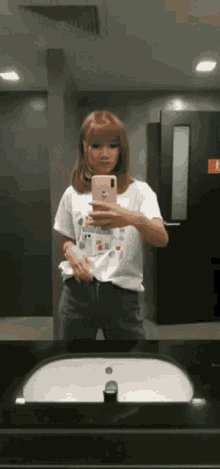 a woman is taking a picture of herself in a bathroom
