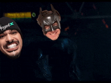 a man wearing a beanie that says blizzard x next to a man wearing a bat mask