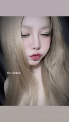 a close up of a woman 's face with the words nhi buon roi written on the bottom