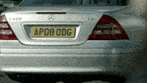 a silver mercedes with a yellow license plate that says ap08 odg