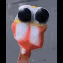 a close up of a person 's hand with a duck 's head on it