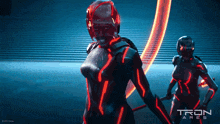 a poster for tron ares shows two women in futuristic costumes