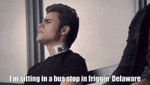 a man sitting in a bus stop in friggin delaware