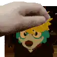a cartoon character wearing a hat and glasses is being touched by a person .