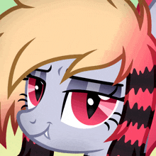a close up of a pony 's face with red and black hair
