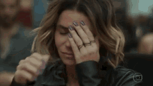 a woman is holding her head with fire coming out of her head