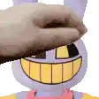 a close up of a person 's hand touching a stuffed bunny 's face .