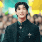 a young man in a suit and bow tie is smiling