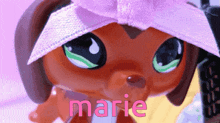 a close up of a littlest pet shop dog with the name marie above it