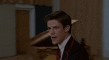 a man in a suit and tie is making a face