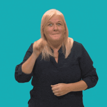 a woman wearing a blue shirt is making a funny face