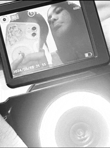 a black and white photo of a woman taking a selfie with the date of 2024/05/10