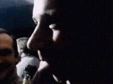 a close up of a person 's face with a blurred background