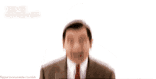 a man in a suit and tie is smiling with a white background