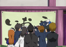 a group of people looking at a sign that says ' i 'm sorry ' on it