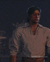 a man in a white shirt is standing in a dark room with nemo-beatrice written on the bottom