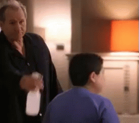 Trying To Train Your Friend To Make Good Decisions GIF - Modern Family Spray Spray Bottle GIFs