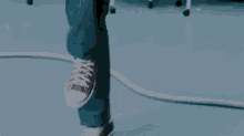 a person wearing red sneakers is walking on a blue surface .