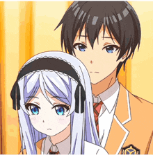 a boy and a girl are standing next to each other and the girl has headphones on