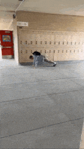 a person doing push ups in front of lockers with the number 10-13