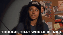 a woman wearing a hat that says challenge accepted stands in front of a bulletin board