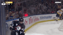 a hockey game is being played in front of an advertisement for tim hortons ticketmaster