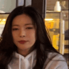 a close up of a woman 's face with her eyes closed .