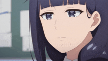 a close up of a girl 's face with a serious expression
