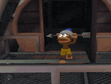 a cartoon monkey is holding an arrow and a blue object