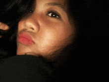 a close up of a woman 's face with red lipstick