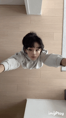 a girl taking a selfie with a gif that says imgplay on the bottom