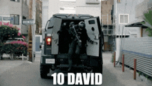 a group of police officers are getting out of a vehicle that says 10 david on the back