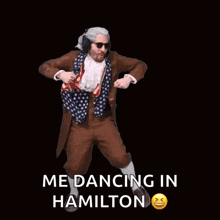 a man in a hamilton costume is dancing with headphones on .