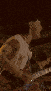 a man wearing a purple harley davidson shirt sings into a microphone