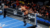 wrestlers in a wrestling ring with a sign that says ' down '