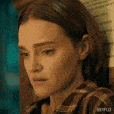 a close up of a woman 's face with netflix written on the bottom