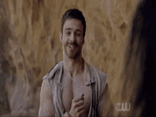 a man without a shirt is smiling in front of a sign that says ew