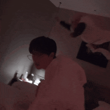 a man in a white shirt is laying in a bed