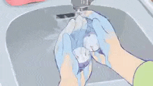 a person is washing a glass in a sink .