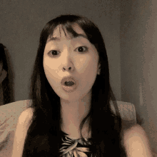 a woman making a surprised face with her mouth wide open
