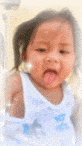 a baby girl wearing a white tank top with a shark on it