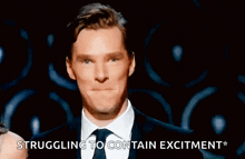 a man in a suit and tie says " struggling to contain excitment "
