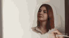 a person is painting a woman 's face with a brush and the words made in animotica are visible on the bottom