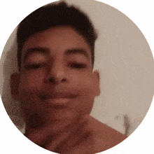 a close up of a young man 's face in a circle with his eyes closed .
