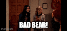 a group of girls standing next to each other with the words bad bear in white letters .