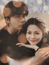 a man and woman are posing for a picture together