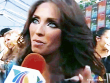 a close up of a woman holding a microphone with the hashtag anahioverdose below her