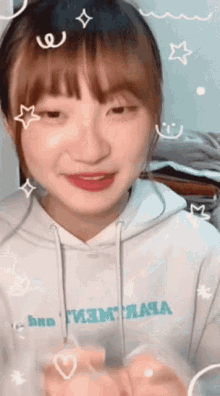 a girl wearing a white hoodie that says " bra "