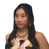 a woman wearing a necklace and earrings makes a face