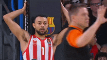 a basketball player in a red and white striped jersey with the number 11 on it